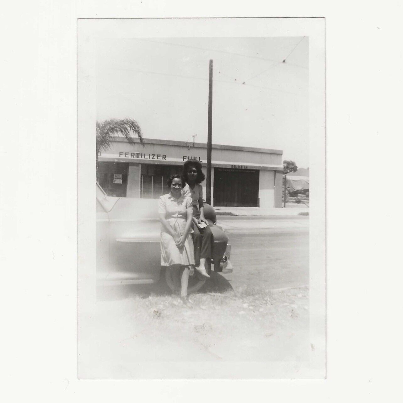 Two Women Sitting On Car Fertilizer Fuel Gas Station 1940s WWII Era Photo