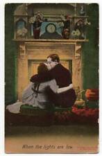 121920 VINTAGE ROMANCE POSTCARD SNUGGLING IN FRONT OF FIRE LIGHTS ARE LOW picture