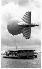 An airship tethered to a barge floats in the air in the Panama Can- Old Photo picture