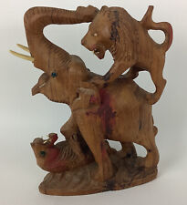 Hand carved elephant in battle with lions 8” tall picture