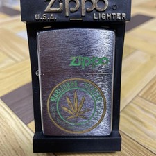 Zippo oil lighter with a marijuana motif picture