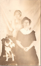 RPPC POSTCARD- TWO YOUNG LADIES IN VINTAGE DRESS WITH DOG IN CHAIR picture