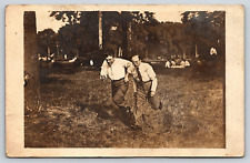 Postcard RPPC Two Men Running Foot Race Cars Outdoors Picnic Park Trees Nature picture