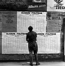Man looking some election posters concerning general election Mila- Old Photo picture