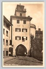 Bad Tolz Germany, Woman Rides Her Bike Down The Road VINTAGE Postcard picture
