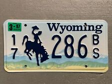 VINTAGE  WYOMING LICENSE PLATE BUCKING BRONCO 17-286BS MAR.1997 STICKER MINT picture