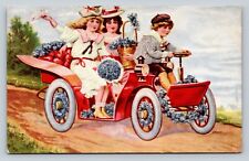 c1909 Boy Driving Two Girls In An Antique Red Car ANTIQUE Postcard picture