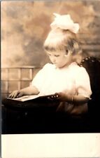 RPPC Serious Girl Reading Book Amber Langmack 3 Years c1910 photo postcard HQ8 picture