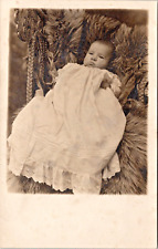 RPPC Plump Serious Baby Long White Gown Fur Rug Wicker Studio Pose P.UN. (N-300) picture
