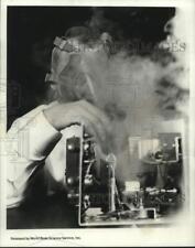 1967 Press Photo Fumes envelop Frank Mellette as he checks out electronic nose picture